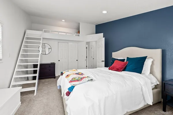 a bedroom with a bed and a view of walk in closet