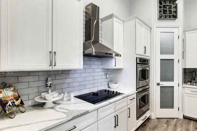 a kitchen with stainless steel appliances white cabinets and a stove