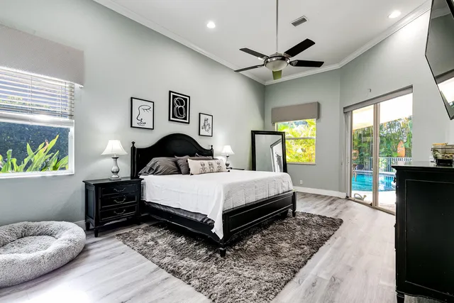 a bedroom with a bed and a large window