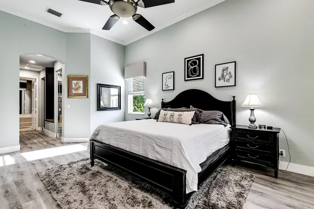 a bedroom with bed and wooden floor