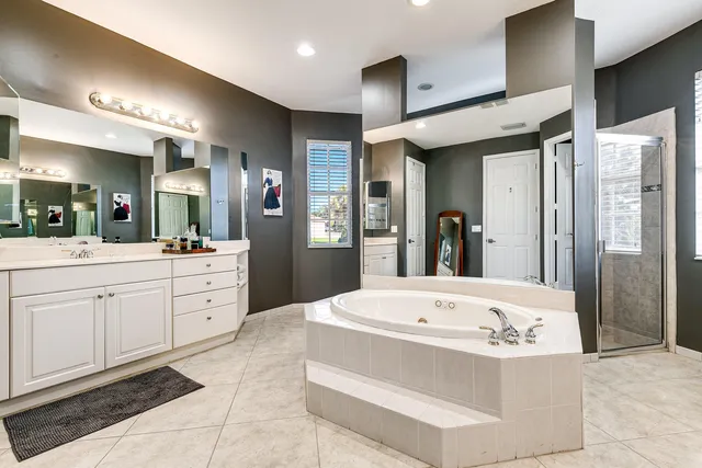 a bathroom with a tub sink and mirror