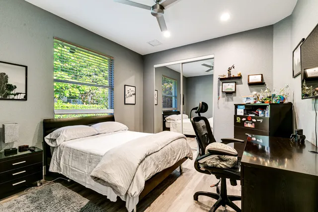 a bedroom with a bed a table and a chandelier