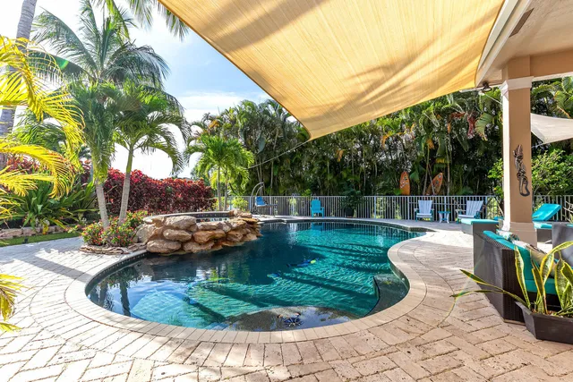 a swimming pool view with a seating space