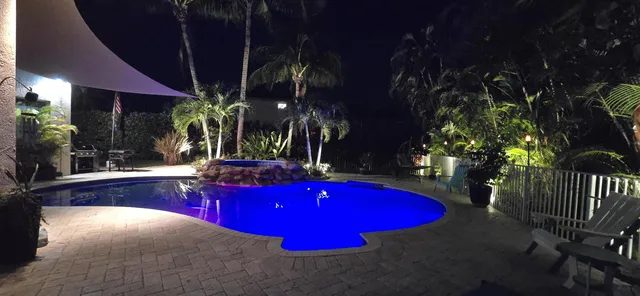 a view of a house with pool and sitting area