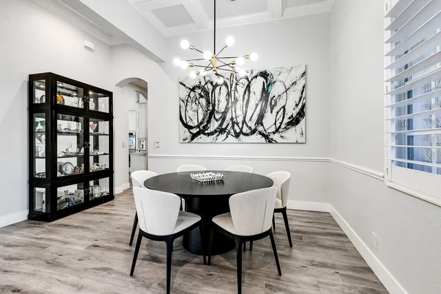 a view of a dining room with furniture and chandelier