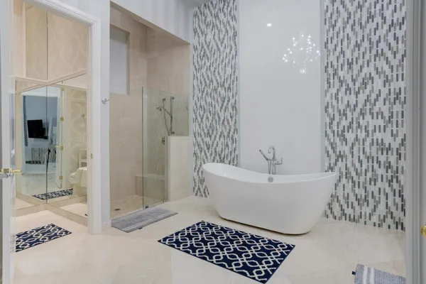 a bathroom with a bathtub a sink and a mirror