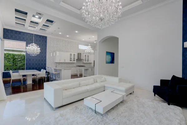 a bedroom with a large bed and a flat tv screen on dresser