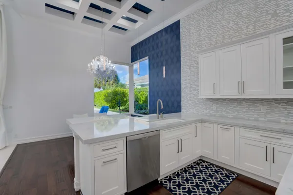 a kitchen with stainless steel appliances a chandelier stove and refrigerator