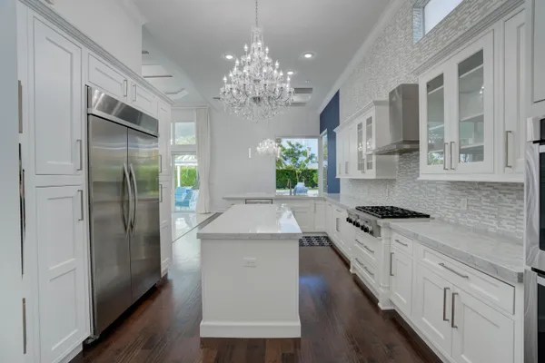 a view of a dining room with furniture and chandelier