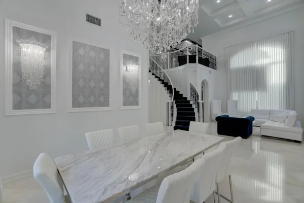 a living room with furniture and stairs