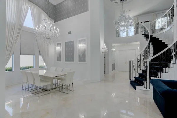 a living room with furniture and stairs