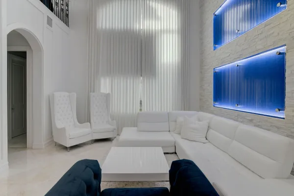 a living room with a couch and a chandelier