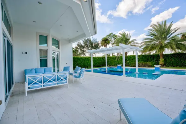 a view of a patio with a table and chairs