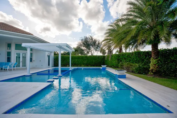 a view of a house with swimming pool and sitting area