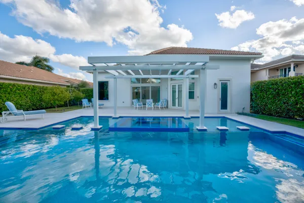swimming pool view with a garden space