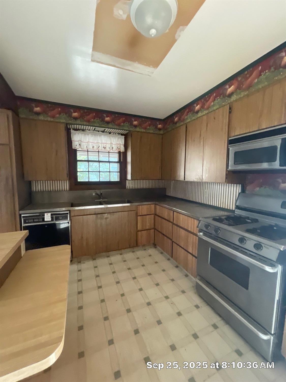 151 South Murdock Avenue Willows, CA 95988 - Photo 5 of 19 a kitchen with stainless steel appliances a stove a sink and a microwave