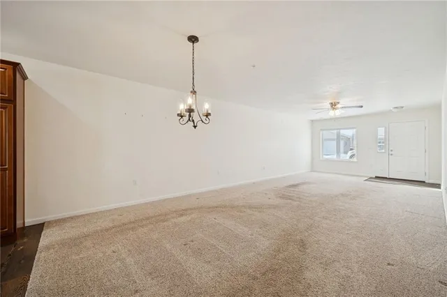 a kitchen with stainless steel appliances granite countertop a stove top oven a sink dishwasher and a refrigerator with wooden floor