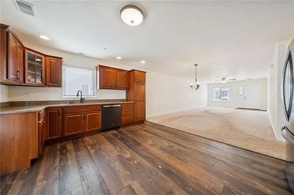 a kitchen with stainless steel appliances granite countertop a sink and cabinets