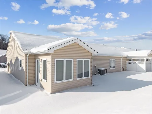 an empty room with windows and ceiling fan