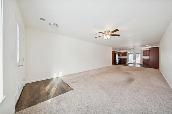 a view of a kitchen with a refrigerator a microwave and a floor to ceiling window