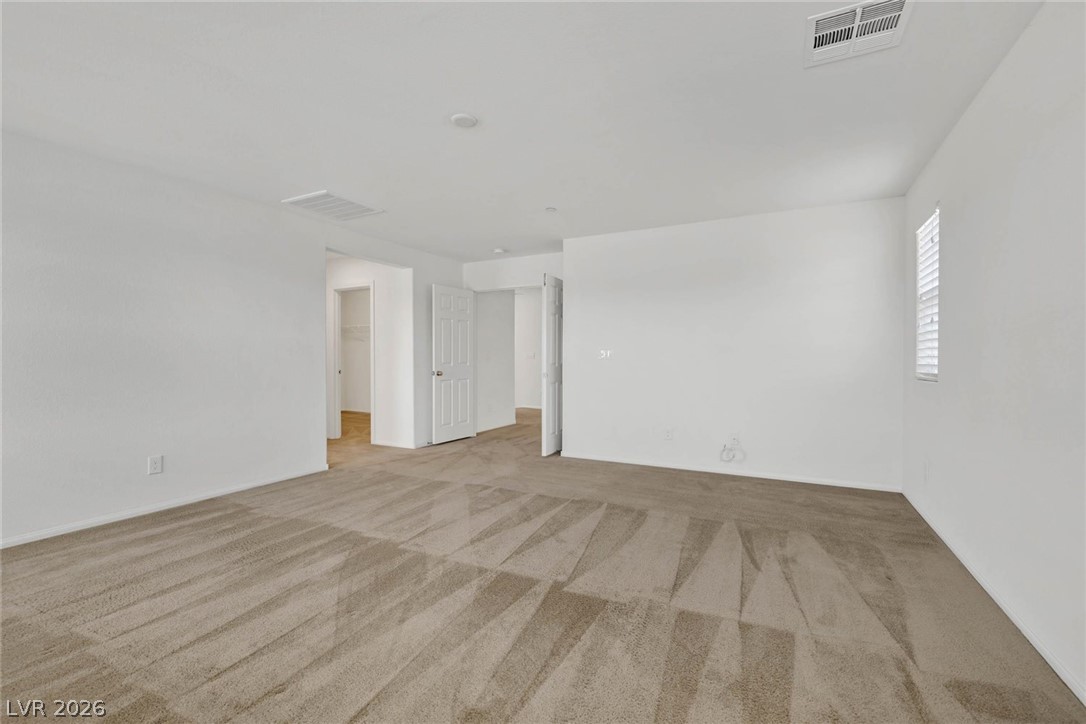 155 Fulgora Street Henderson, NV 89074 - Photo 10 of 30 An airy bedroom with fresh carpeting and ample natural light, ready for personalization.