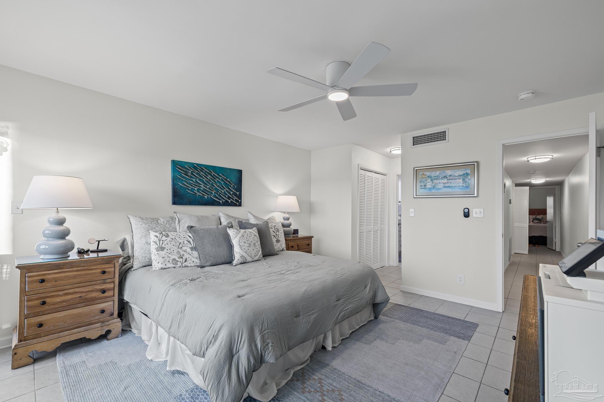 14100 River Road, Unit 112A Pensacola, FL 32507 - Photo 23 of 64 a bedroom with a bed and a chandelier