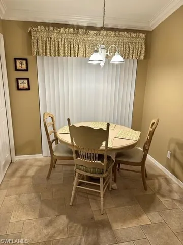 a view of a dining room with furniture and chandelier