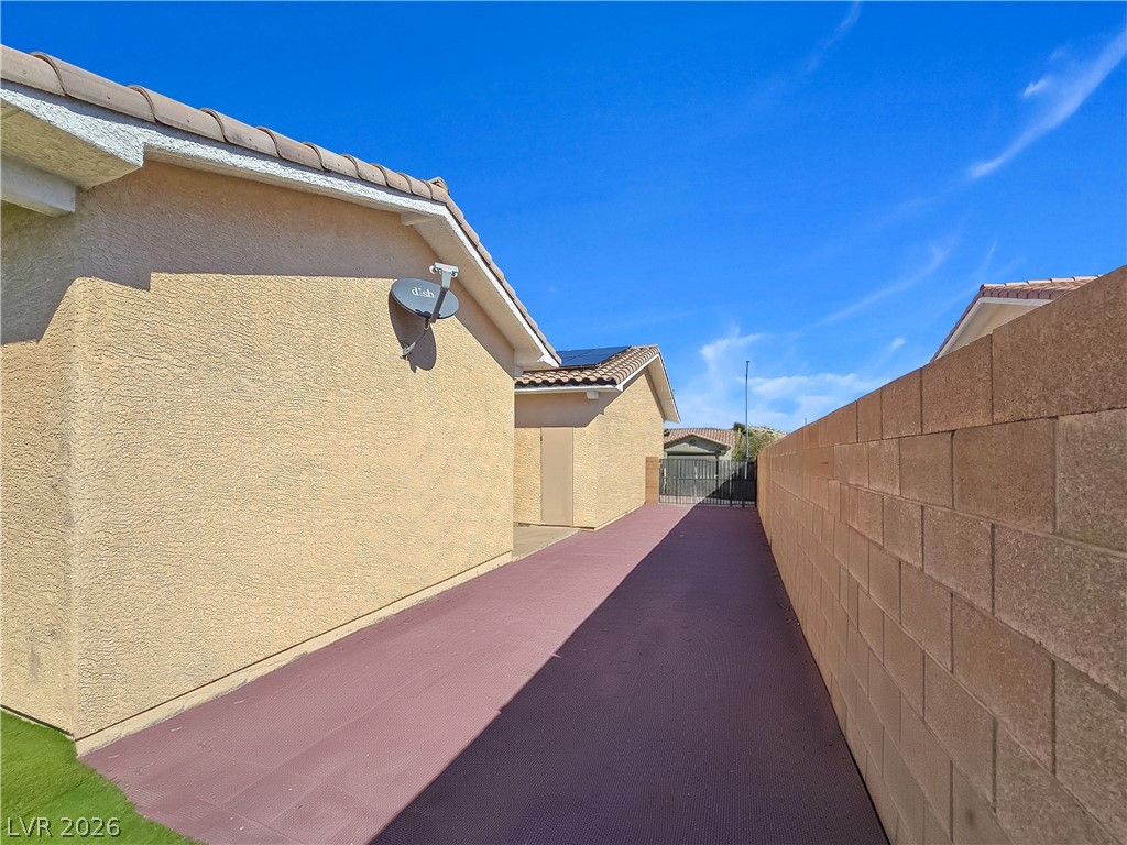 2485 Morrow Ridge Place Laughlin, NV 89029 - Photo 37 of 38 Secure, private pathway features robust block wall fencing and convenient side gate access.