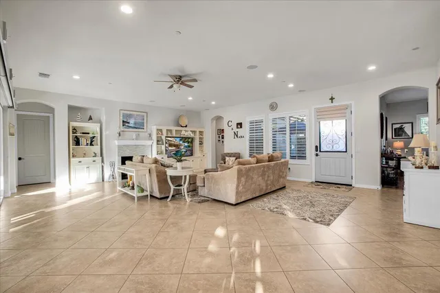 a large white kitchen with lots of counter space and stainless steel appliances