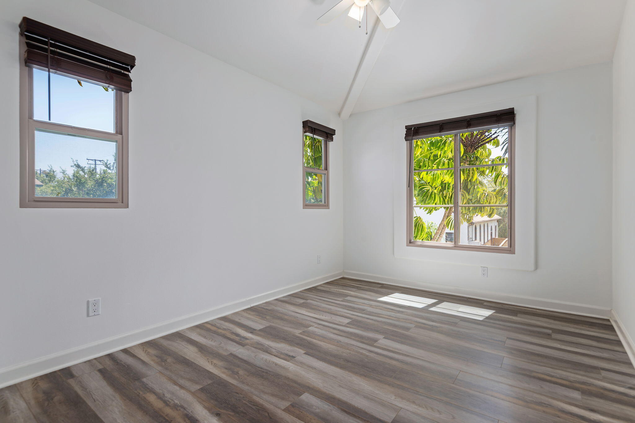 330 West Canon Perdido Street Santa Barbara, CA 93101 - Photo 14 of 44 an empty room with window and wooden floor