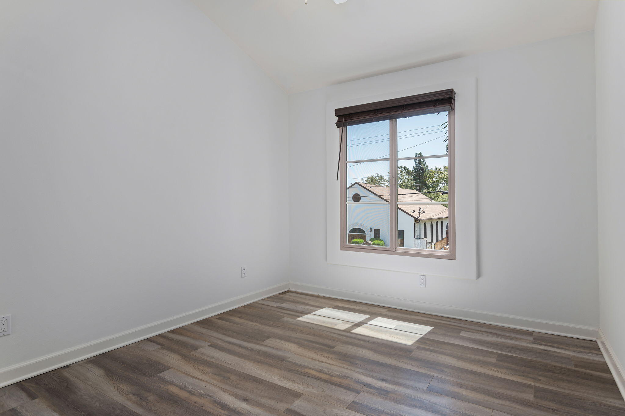 330 West Canon Perdido Street Santa Barbara, CA 93101 - Photo 18 of 44 an empty room with wooden floor and windows