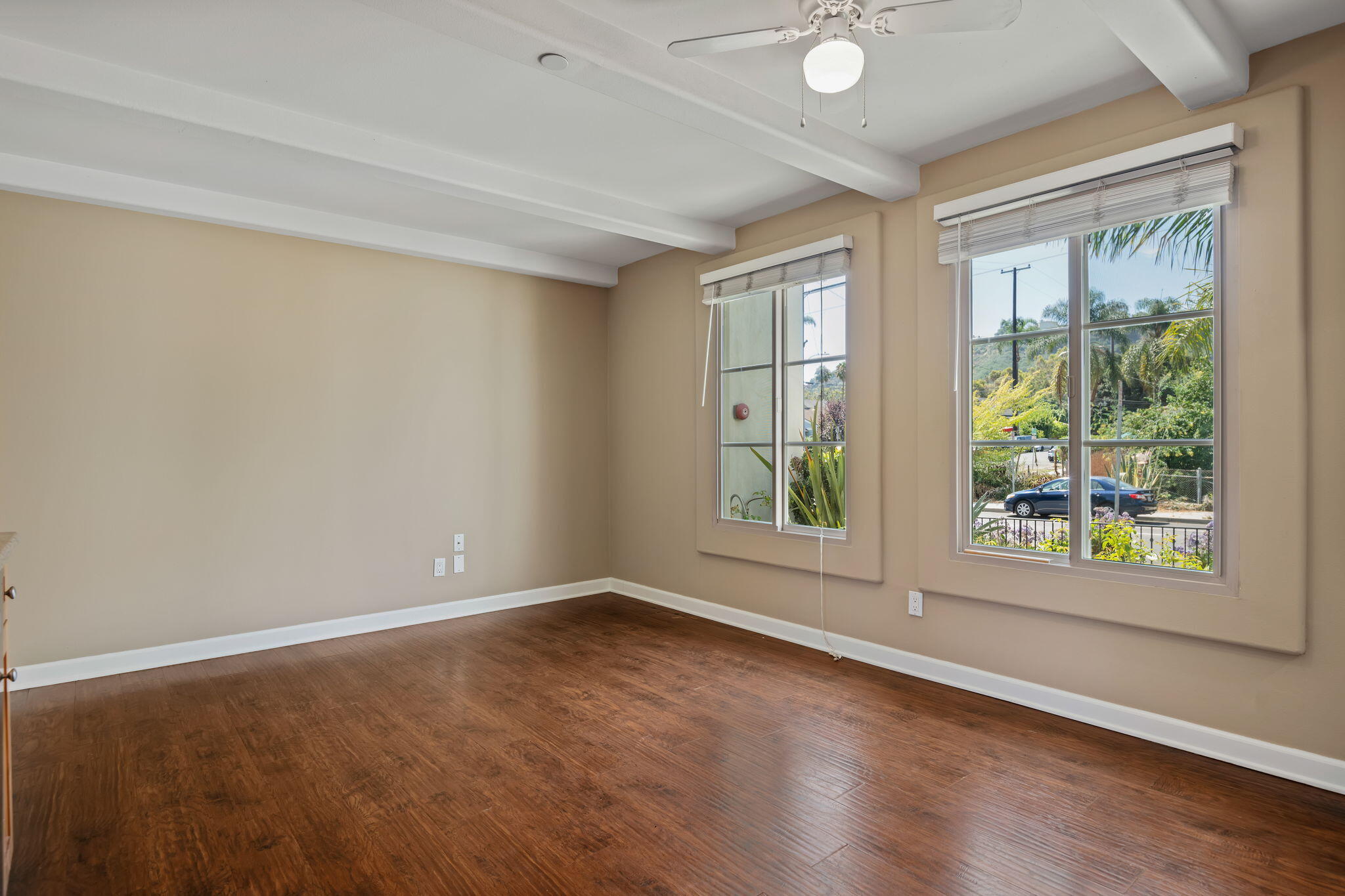330 West Canon Perdido Street Santa Barbara, CA 93101 - Photo 29 of 44 an empty room with wooden floor and windows