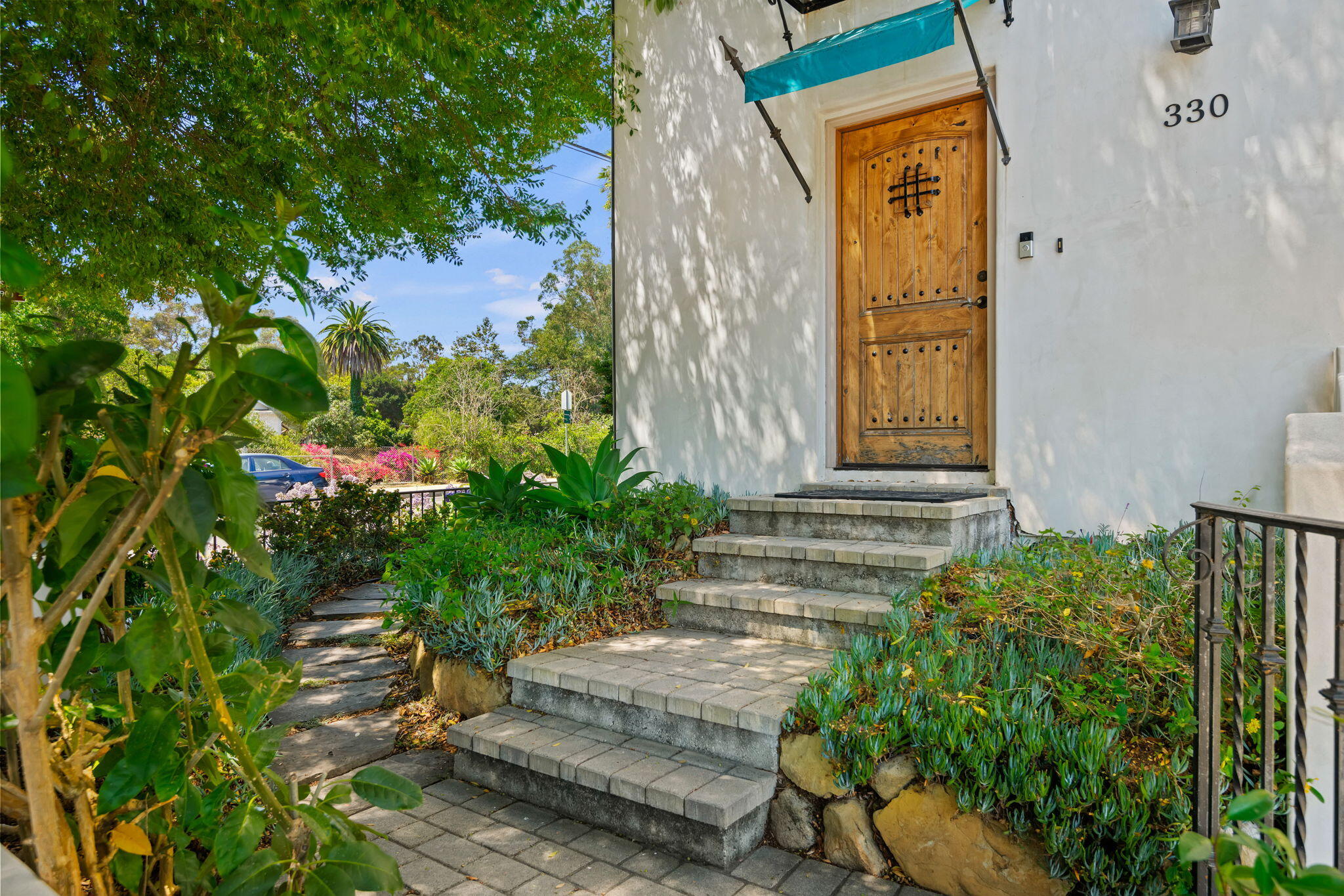 330 West Canon Perdido Street Santa Barbara, CA 93101 - Photo 3 of 44 a front view of a house with a yard