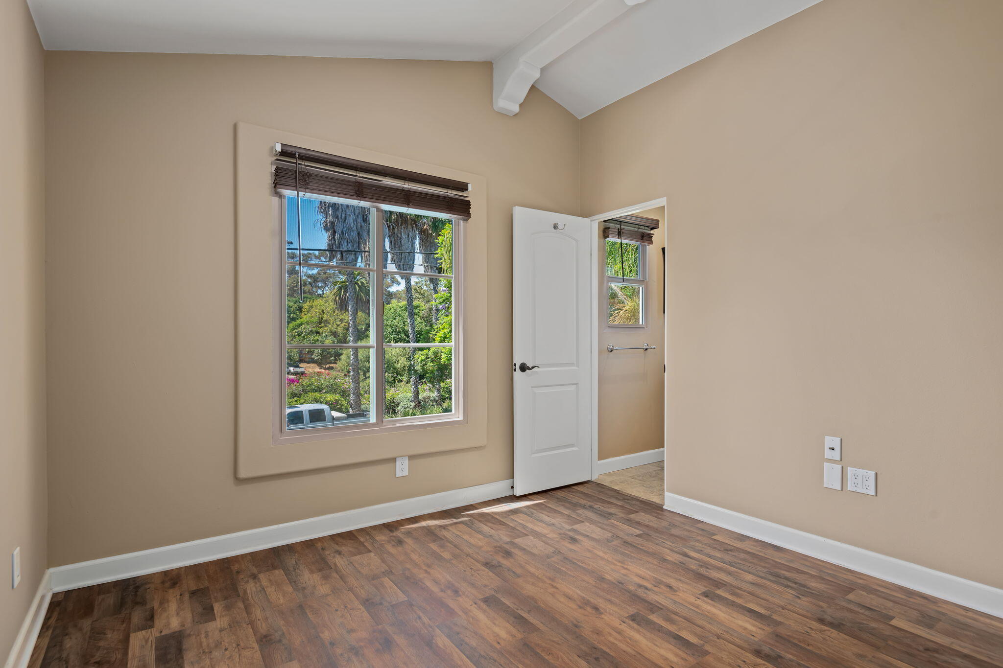 330 West Canon Perdido Street Santa Barbara, CA 93101 - Photo 35 of 44 an empty room with wooden floor and windows