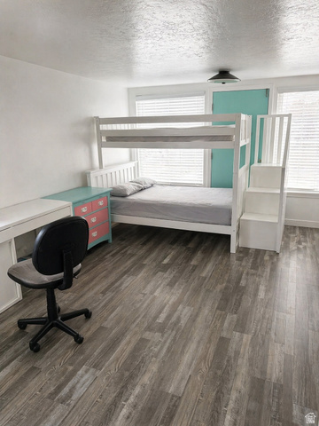 287 100 North Orem, UT 84057 - Photo 11 of 18 Bedroom featuring dark wood-style flooring, multiple windows, and a textured ceiling