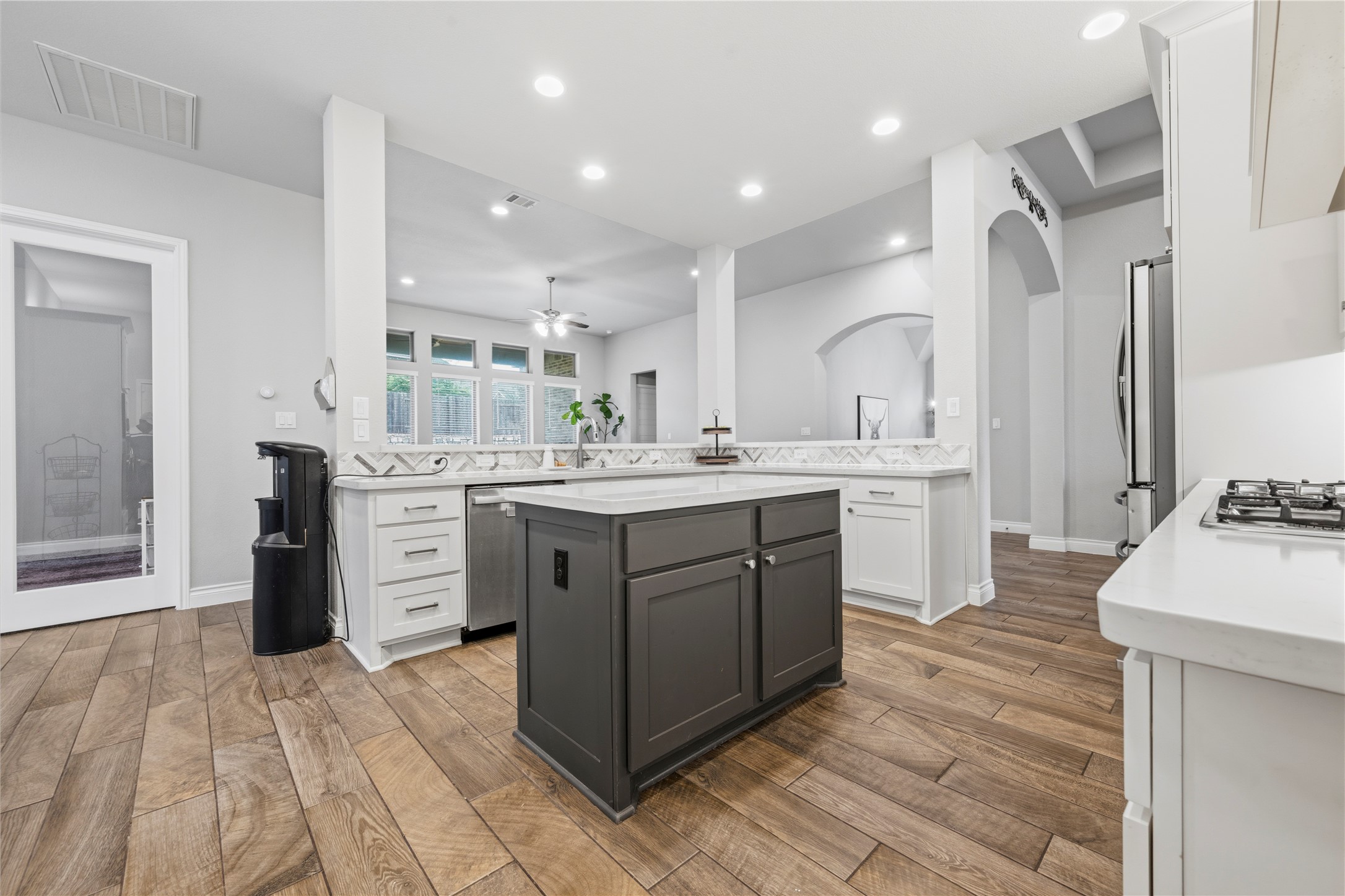 140 Catani Loop Georgetown, TX 78628 - Photo 13 of 36 Bright, open-concept kitchen with a central island and rich hardwood flooring flows seamlessly into the main living areas.