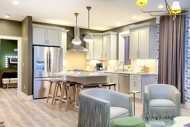 a large kitchen with a table and chairs