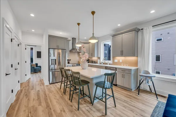 a kitchen with stainless steel appliances granite countertop a sink stove and refrigerator