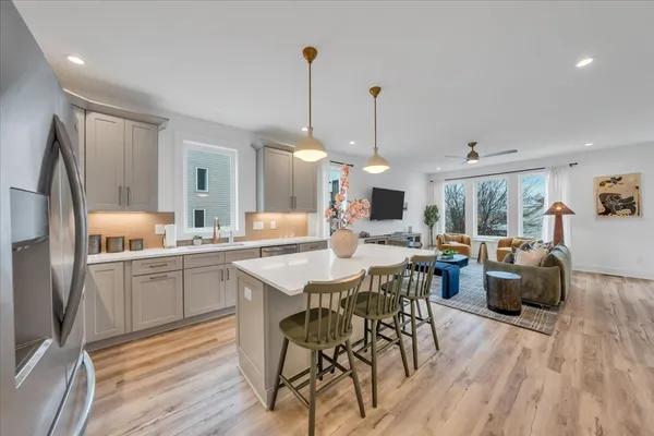 a kitchen with stainless steel appliances granite countertop a stove a sink and a refrigerator