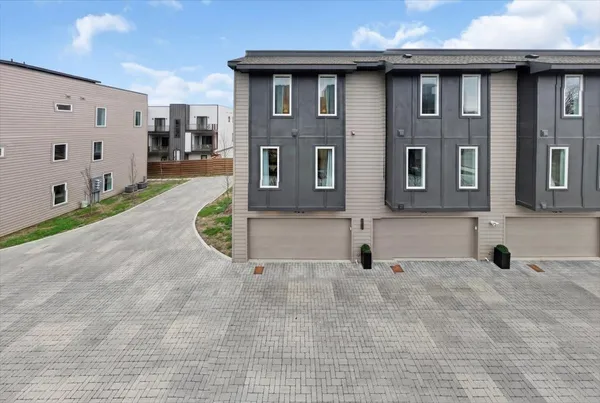 a view of a brick house with many windows