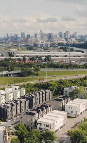 a view of a city with lawn chairs and a big yard
