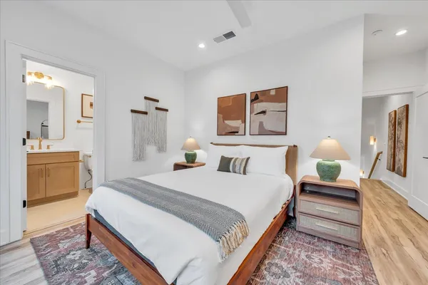 a view of roof deck with couches and wooden floor