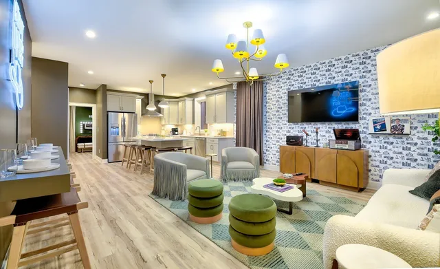 a living room filled with furniture and a flat screen tv