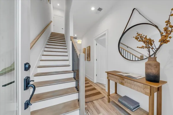 a living room with furniture and a mirror