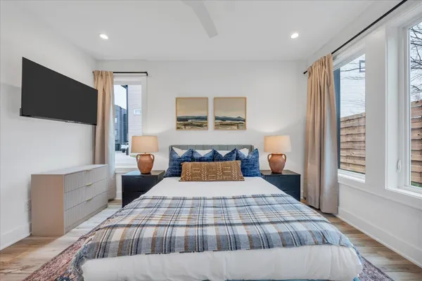 a bedroom with a bed and a flat screen tv