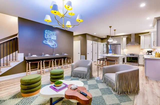 a living room with furniture and kitchen view