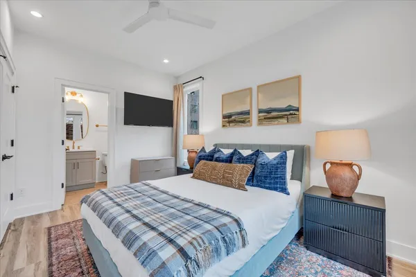 a spacious bedroom with a large bed and a large window