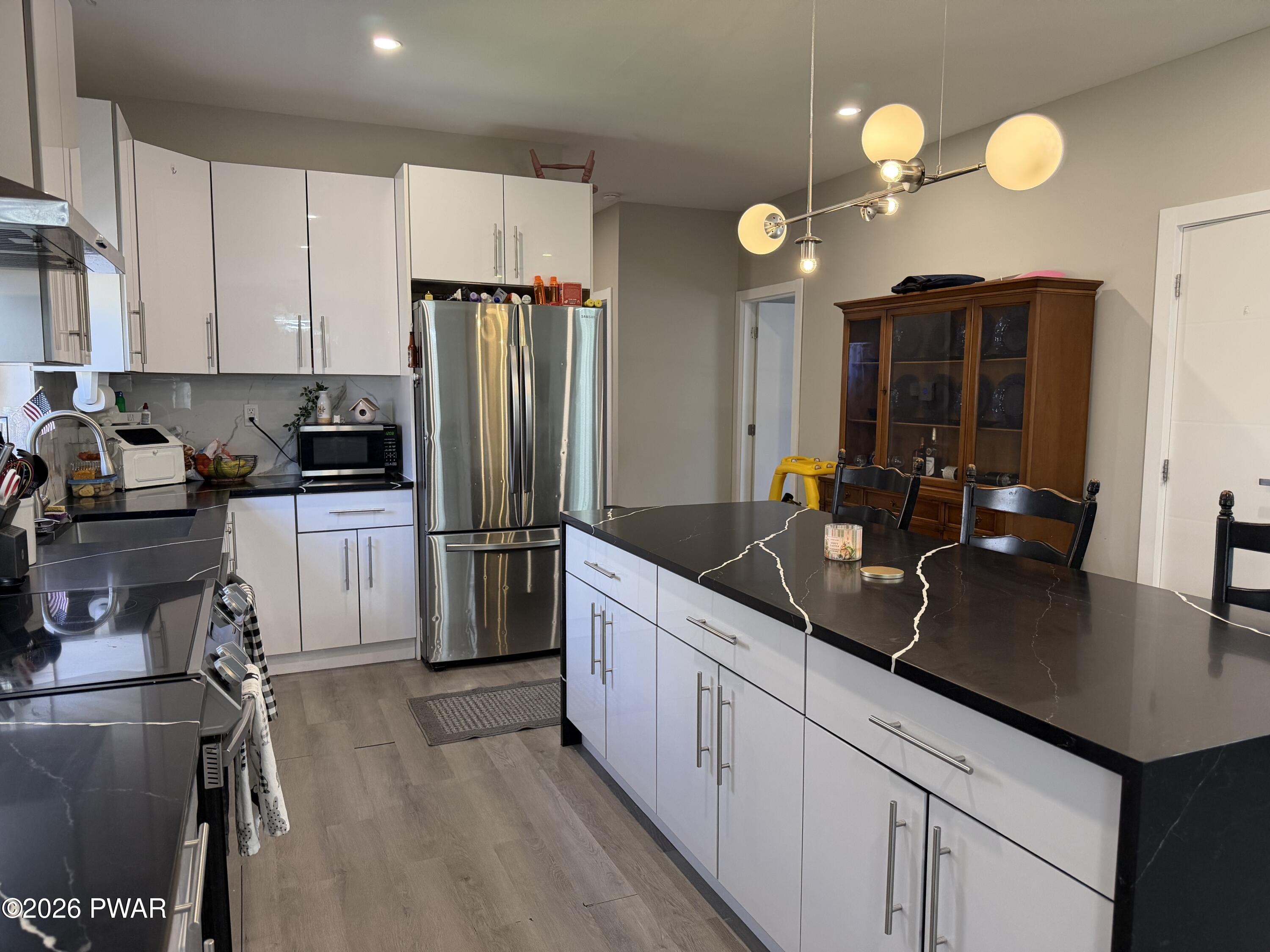 801 Maple Ridge Court Hawley, PA 18428 - Photo 15 of 55 a kitchen with a sink refrigerator and microwave