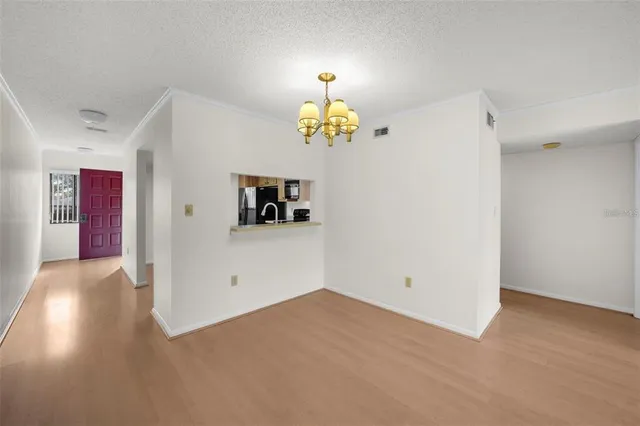 a view of a chandelier fan and fire place