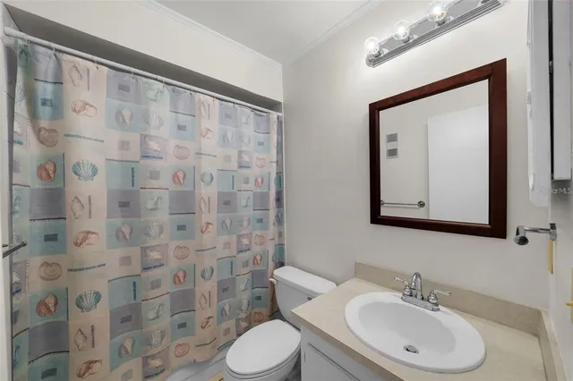 a bathroom with a toilet a sink and a mirror